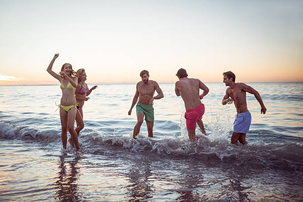 istock Happy friends having fun in the water 481689276