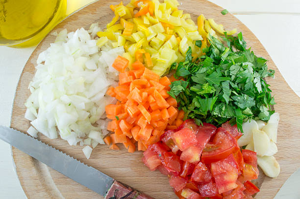 istock Colorful sliced vegetables on a wooden plate with a knife 481693696