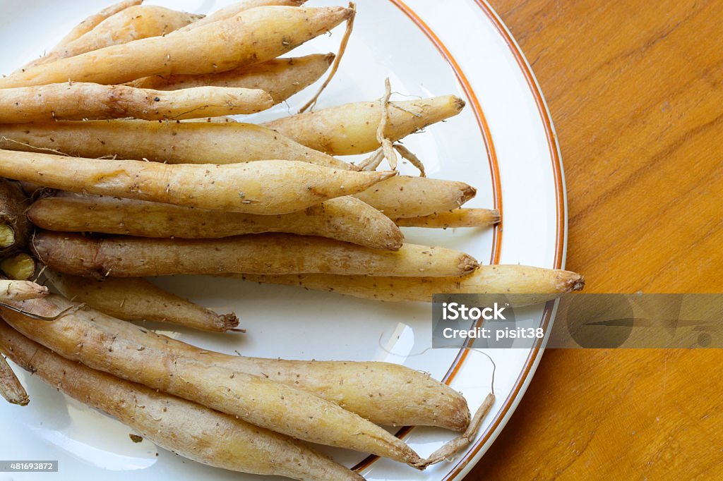 Fingerroot herb on white dish, wood background 2015 Stock Photo