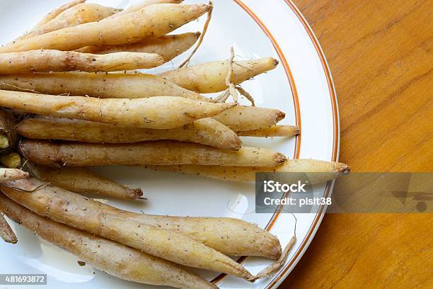 Fingerroot Herb On White Dish Wood Background Stock Photo - Download Image Now - 2015, Brown, Colors