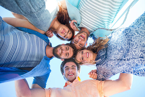 istock Happy friends standing in circle and looking at camera 481694488