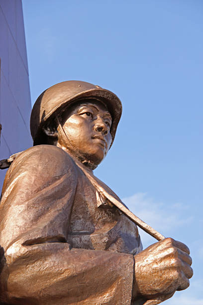 Pyongyang, North Korea - August 14, 2013: Statue of soldier at the Victorious Fatherland Liberation War Museum. The museum has exterior exhibits including downed U.S. aircraft, captured tanks and hardware, statue park, and the captured American spy ship Pueblo. The main building is a magnificent structure, but photography inside is not allowed.