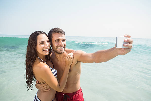 istock happy couple taking a selfie 481698352