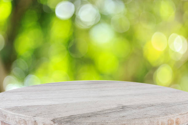 istock Top wooden table with sunny abstract green nature background 481698832