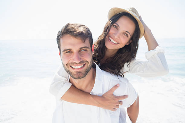 Handsome man doing piggy-back to his girlfriend