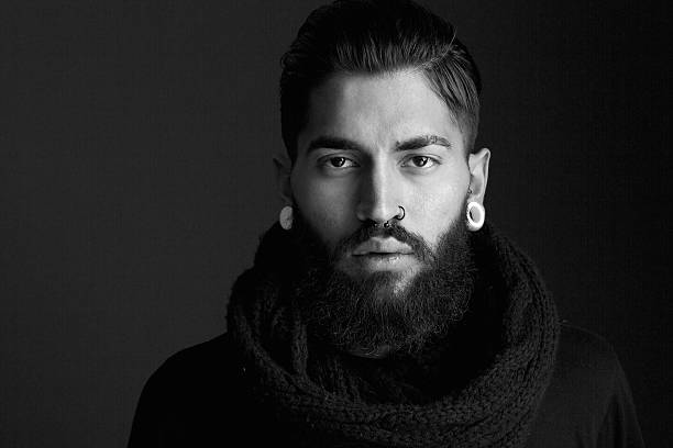 Male fashion model with beard Black and white close up portrait male fashion model with beard and piercing Pierced stock pictures, royalty-free photos & images
