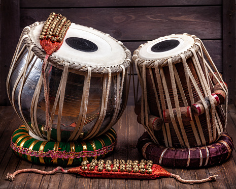 Tabla drums and bells for Indian dancing on wooden background