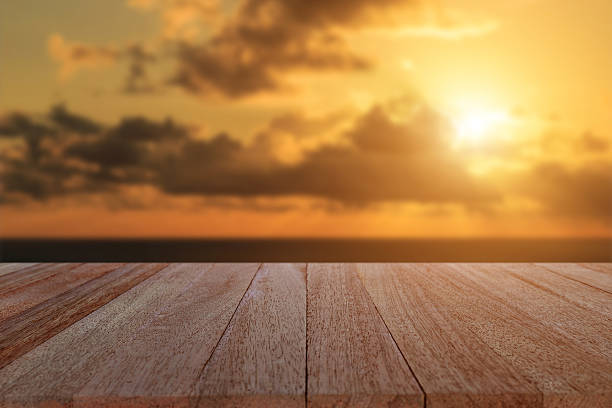 istock Top wooden table and blur sunset background 481705566