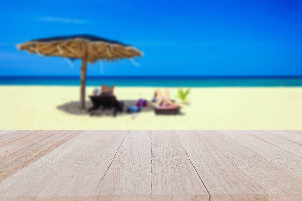 istock Top wooden table and blur of tropical beach background 481705588