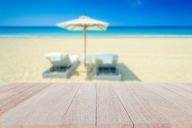 istock Top wooden table and blur of tropical beach background 481705594