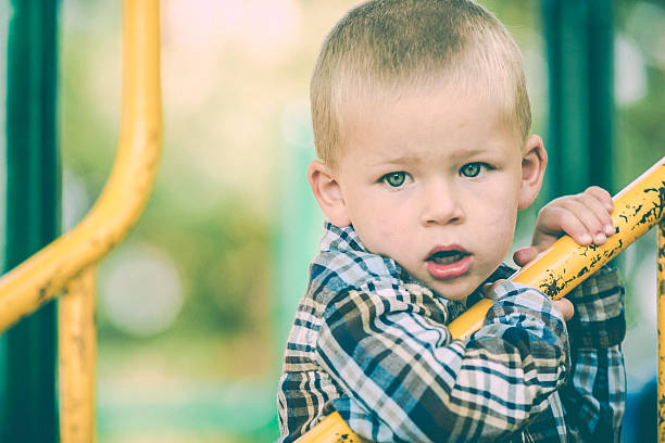istock Little boy playing alone at outdoor playground 481710864