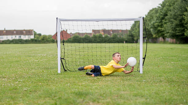istock Boy playing football and saving a goal 481710982