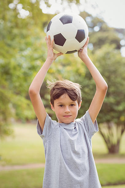 istock Boy looking at camera and holding a ball 481714880