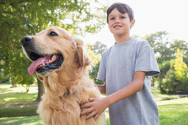 istock Little boy with his dog in the park 481714934