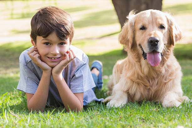 istock Little boy looking at camera with his dog 481714942