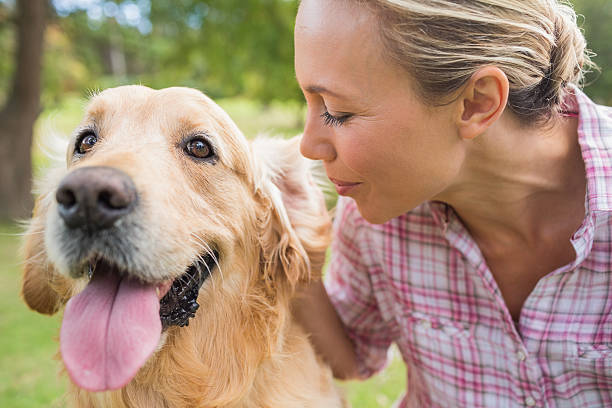 istock Happy blonde with her dog in the park 481716438