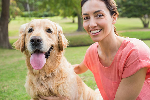 istock Pretty brunette looking at camera with her dog 481716448