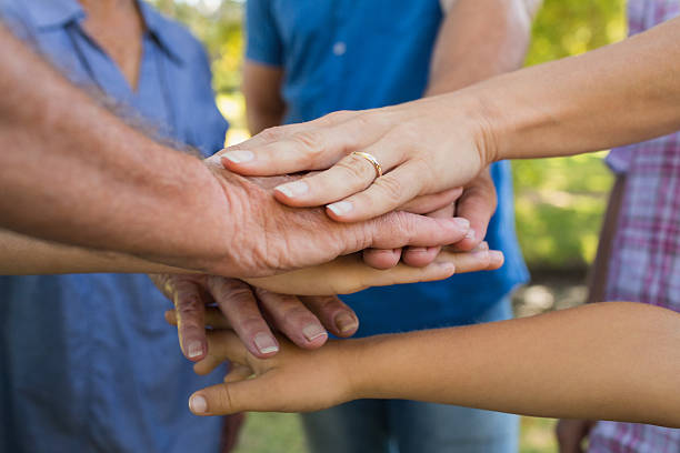 istock Family putting their hands together 481717448