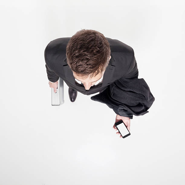 istock Rear view of businessman holding briefcase & mobile 481717727