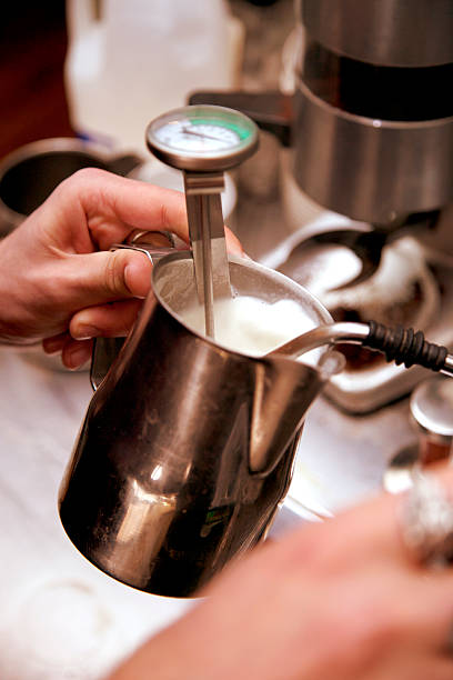 Foaming the milk stock photo