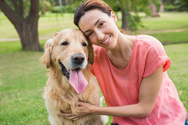 istock Pretty brunette looking at camera with her dog 481720914