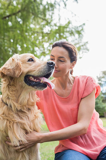 istock Pretty brunette with her dog in the park 481720916