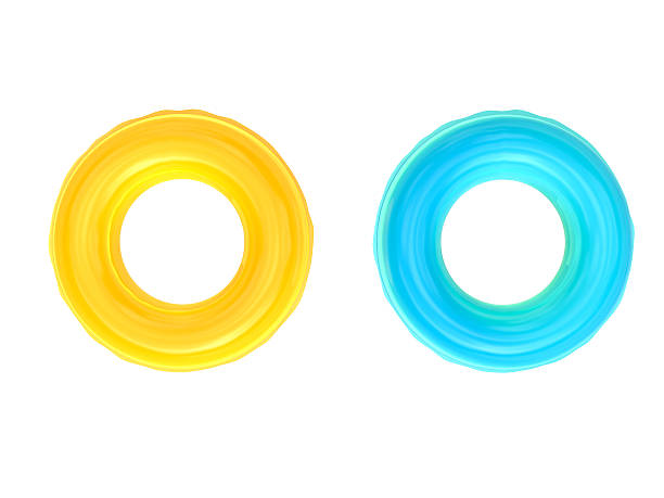 swim rings yellow and blue swim rings on white background inner tube stock pictures, royalty-free photos & images