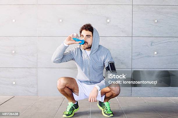 Young Man Resting On A Run Stock Photo - Download Image Now - Drinking, Sport Drink, Young Men