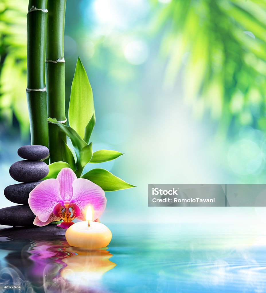 spa still life - zen concept in nature candle and stone with bamboo on water Zen-like Stock Photo