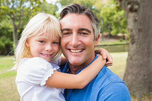 istock Happy father smiling at camera with his daughter 481728222