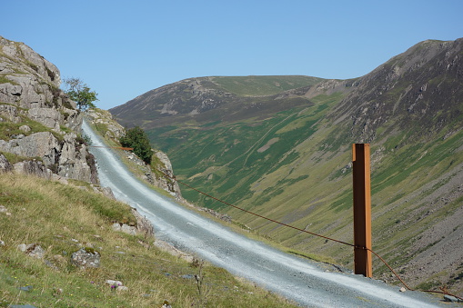 Road / track with rusting post at Honister mine / quarry, Cumbria, UK
