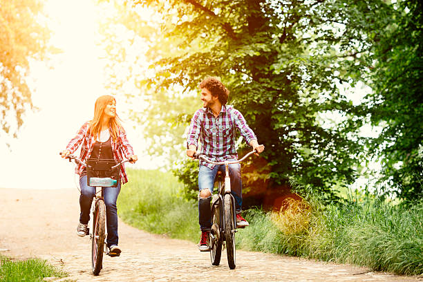istock Cheerful Couple Riding Bicycle Together In A Nature. 481728922