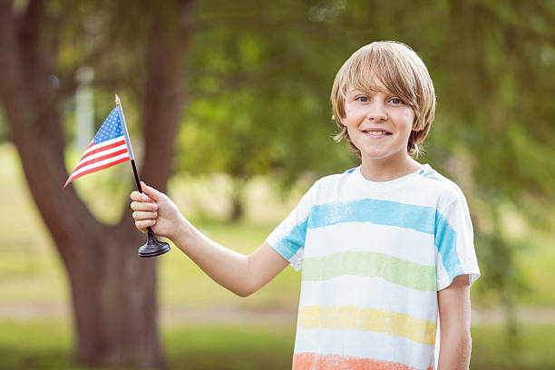 istock Young boy holding an american flag 481729150