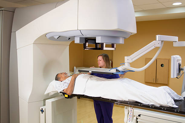 Elderly Man Receiving Radiotherapy Treatments for Prostate Cancer Elderly Man Receiving Radiotherapy Treatments for Prostate Cancer radiotherapy stock pictures, royalty-free photos & images