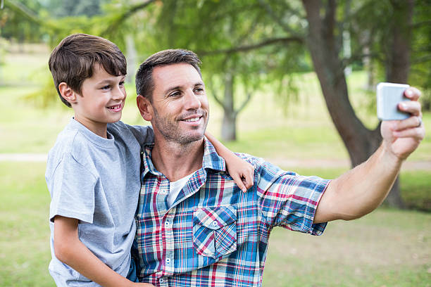 istock Father and son taking a selfie in the park 481730348