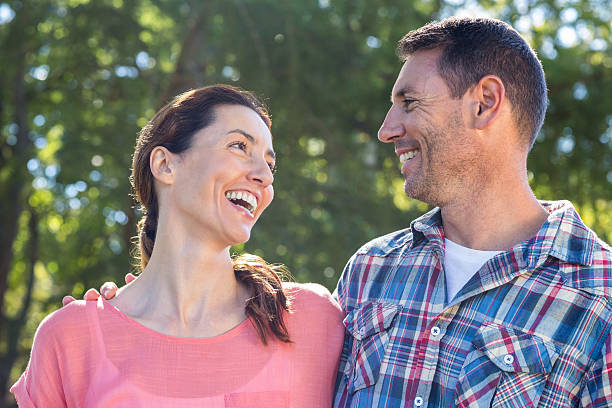 istock Happy couple smilling in park 481731256