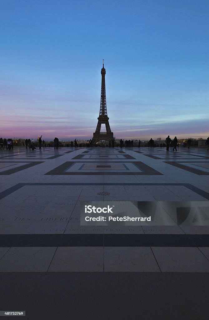 Eiffel Tower at sunset Tourists enjoying the Eiffel Tower from the Trocadero Esplanade, Paris. France. Architecture Stock Photo