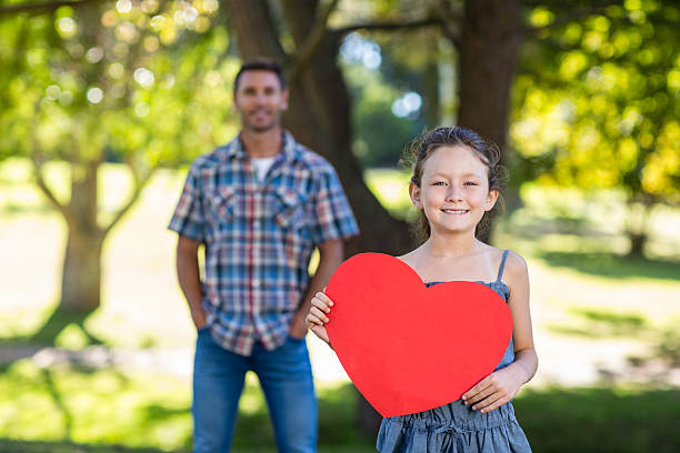 istock Father and daughter smiling in the park 481735030
