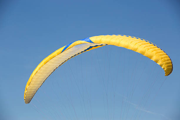 istock Yellow paraglider with blue sky 481736024