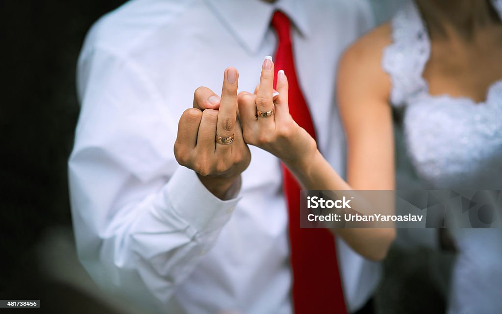 Wedding rings on fingers newly married Wedding rings on middle finger newly married 2015 Stock Photo