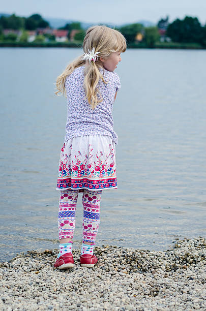 istock blond girl at pond 481738600
