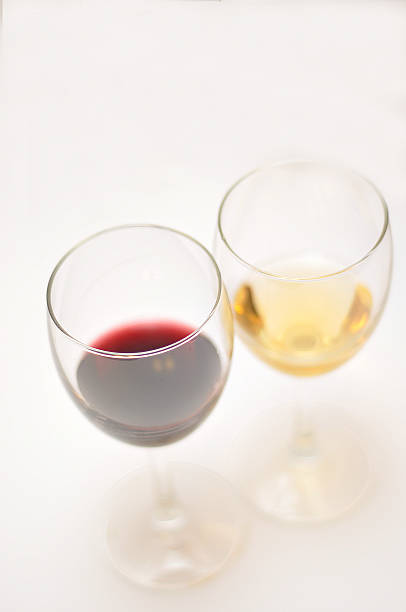 istock Two glasses of red and white wine  isolated on white 481738886