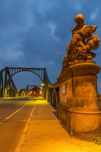 Male statue with fish at the beginning of the Glienicke Bridge