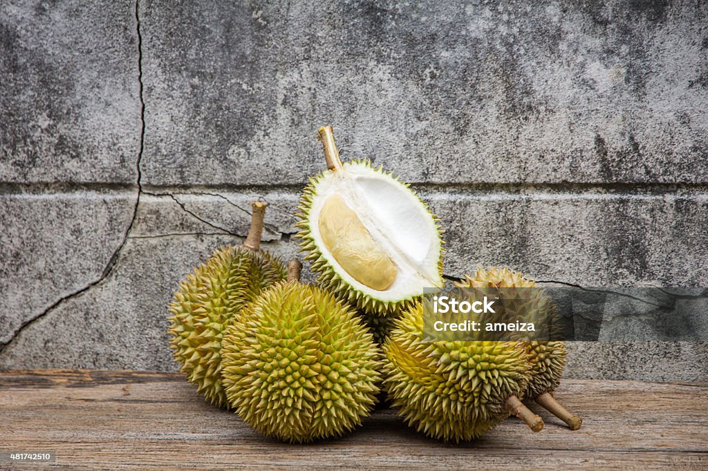 durian, king of fruit riped durain on wooden table with rusty background Durian Stock Photo