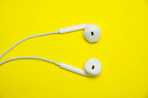 istock white earphones on yellow background. 481743260