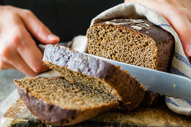istock Rye bread on wood board, dark background 481744306