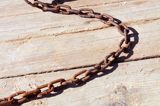 metal chain on the background of the pier boards