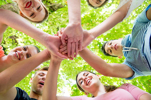 istock Young People Standing in a Circle with Hands Together 481745262