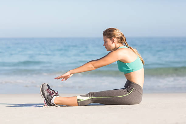 istock Fit woman stretching beside the sea 481746014