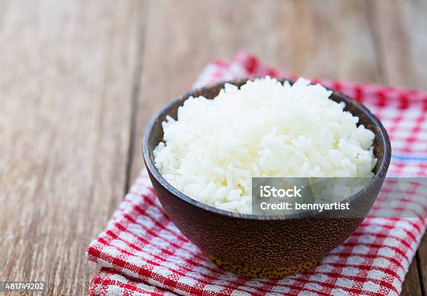 Jasmine Rice In A Bowl On Wood Table Stock Photo - Download Image Now - White Rice, Cooked, Rice - Food Staple